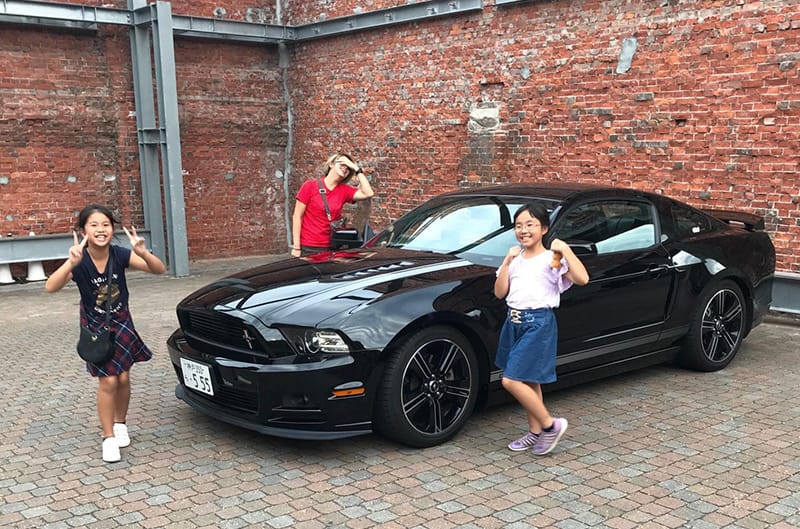 Kids posing with Mustang