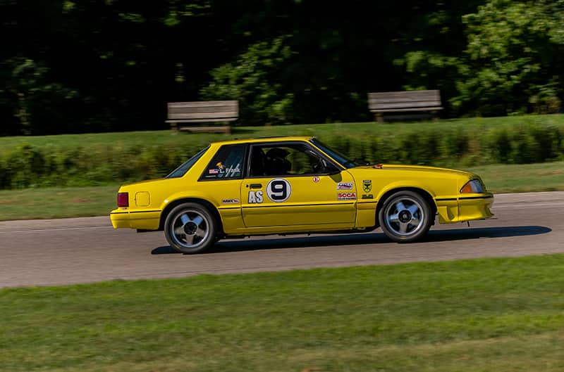 Yellow Foxbody Mustang on track