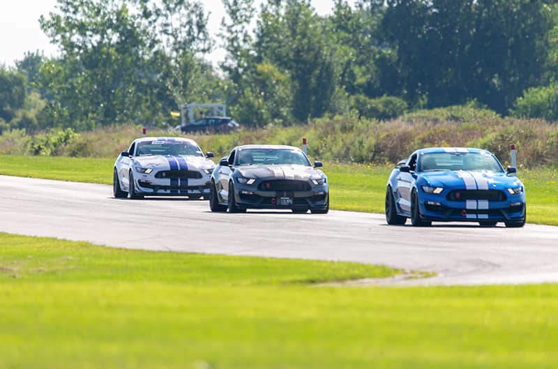 Several Shelby S550 Mustangs on track