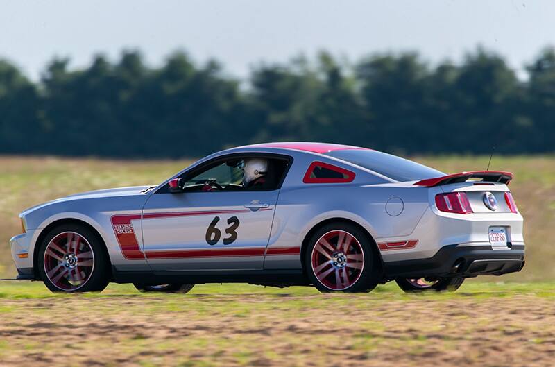 Silver and Red Boss 302 Mustang on track