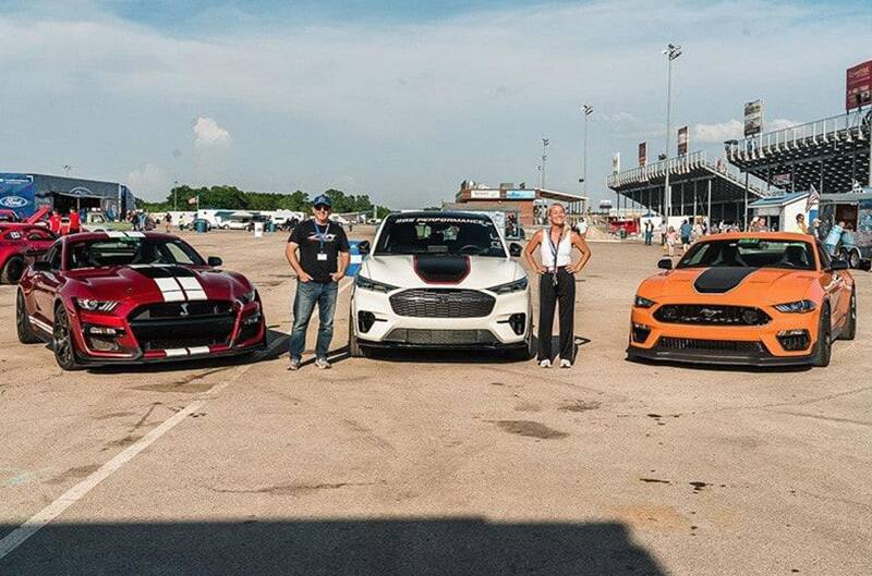 Two mustangs and MachE lined up for Photo at track