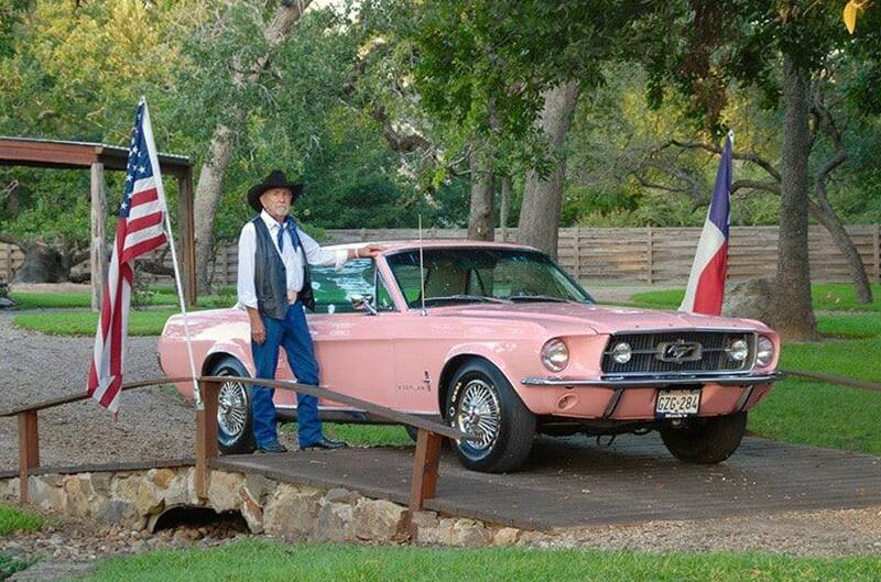 Man standing with Pink First gen mustang