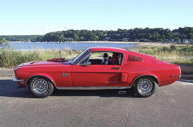 Side photo of Red 1960s ford mustang