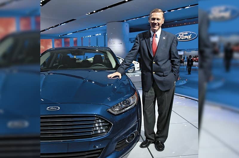 Photo of man standing next to ford fusion