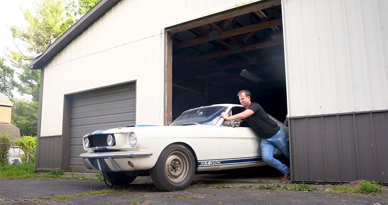 Man pushing Shelby GT350 out of barn