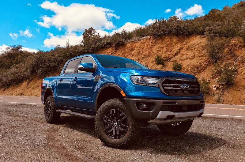 Front profile of blue Ranger F150 on side of the road