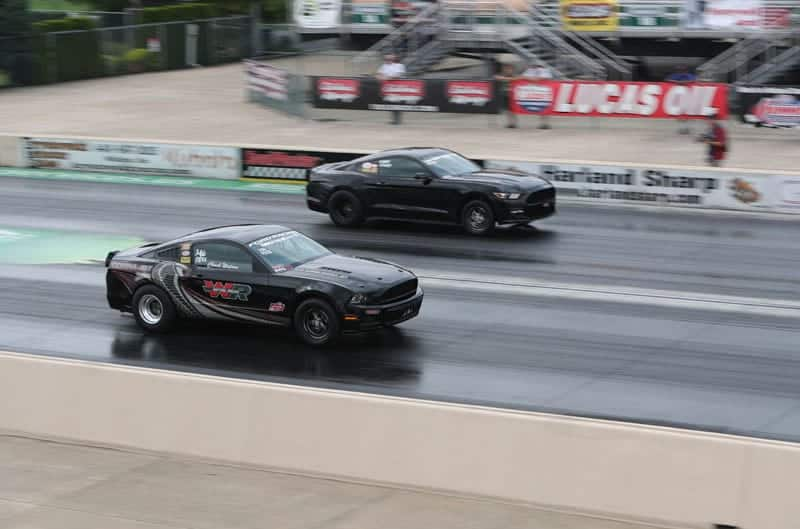 Two black Cobra Jets speeds down track