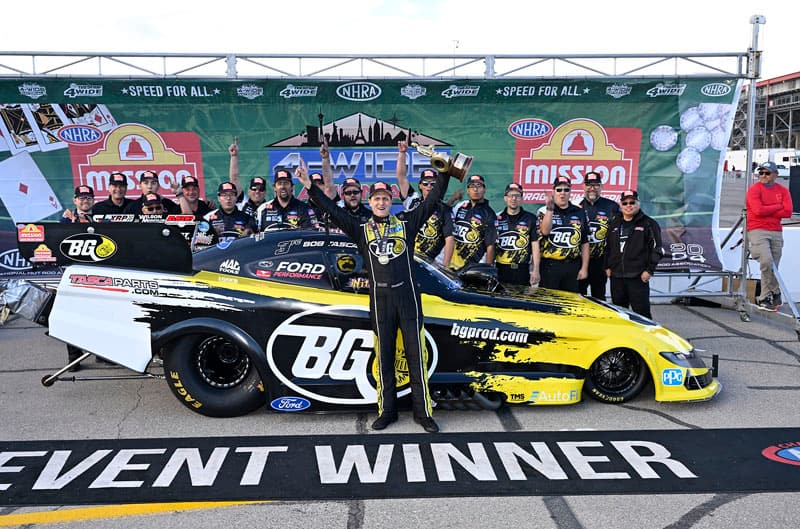 Tasca with team in front of Mustang