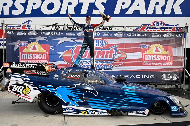 Tasca on top of Mustang with trophy
