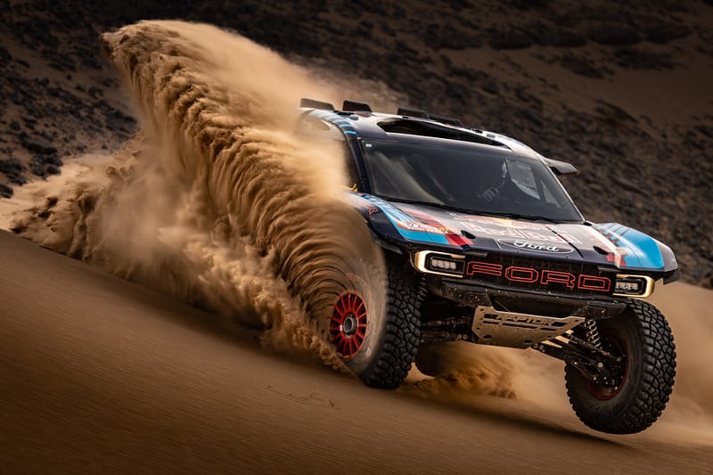 Ford Raptor T1+ throwing sand in dunes