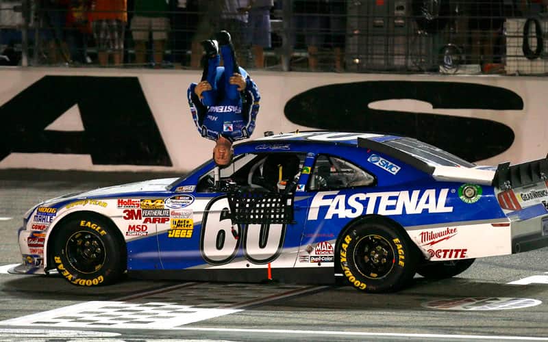 Edwards is pictured doing his patented backflip mid-air after securing the first series win for Mustang at Texas Motor Speedway in 2011