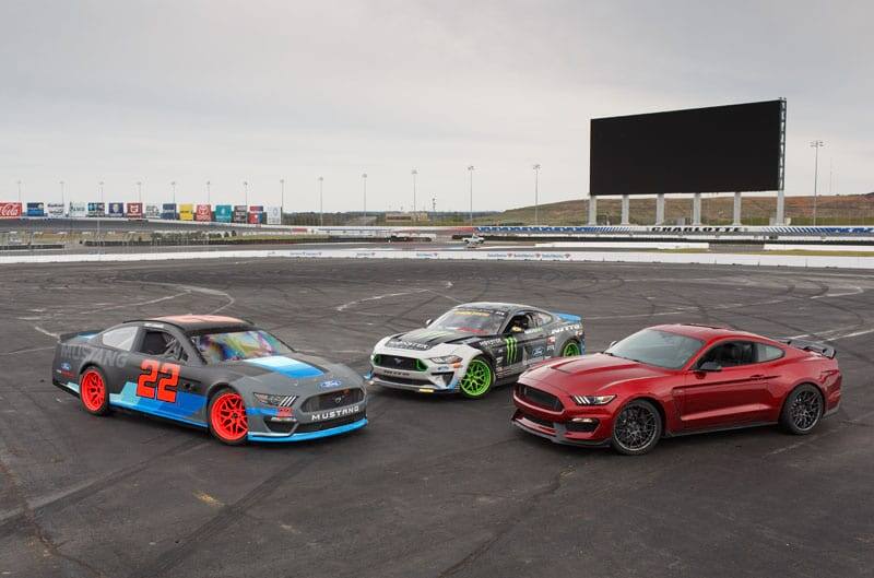Three colorful Ford Mustangs are pictured at the new Roval infield of Charlotte Motor Speedway