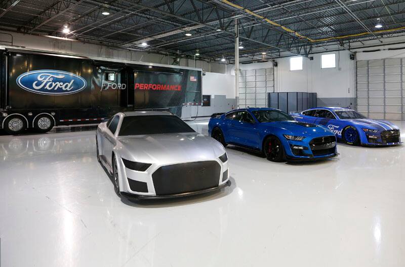 Trio of the clay, production and stock Next Gen Mustang in the garage