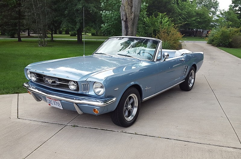 Blue Convertible Mustang in the driveway