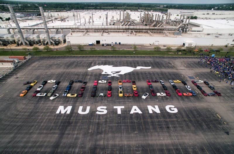 Overhead shot of parking lot with Mustang Logo and Mustangs in the formation of 10000000