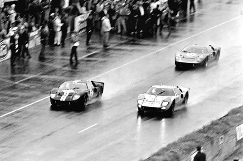 Three Ford GT40s making their way to the finish line 