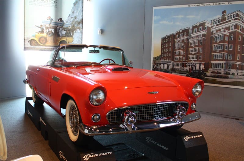 Front of a red Thunderbird droptop with roof down on display