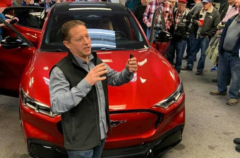 Dave Pericak in front of a 2021 Mustang Mach-E in Red