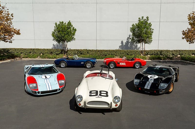 Two Ford GT40s and three Shelby Cobras on display from the movie Ford Vs. Ferrari