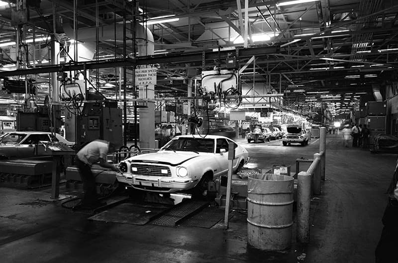 Black and white photo of Mustang two rolling down the assembly line