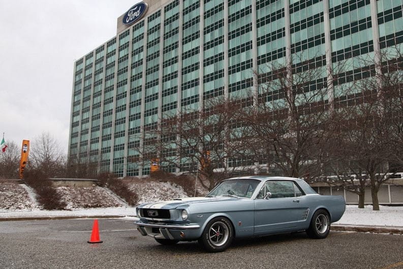 A classic Ford Mustang in the parking lot of Ford World Headquarters 