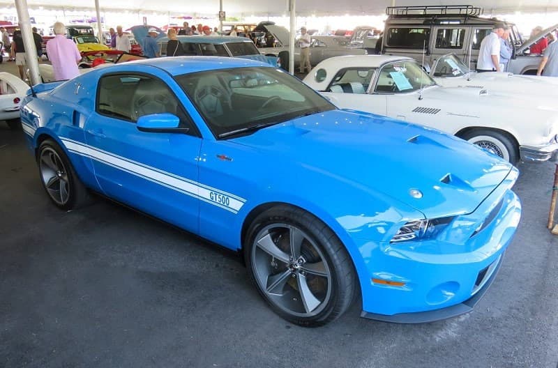 A blue and white Mustang GT500 on display at Barrett Jackson in Palm Beach
