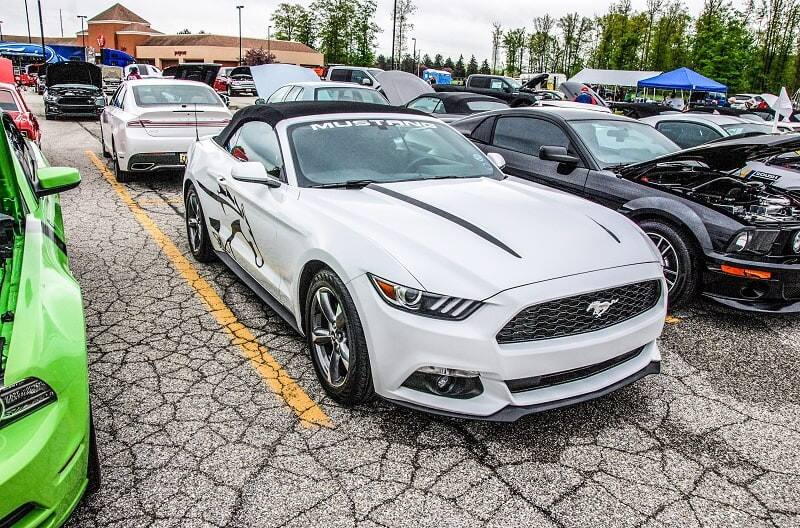 A front side view of a white Ford Mustang on display 