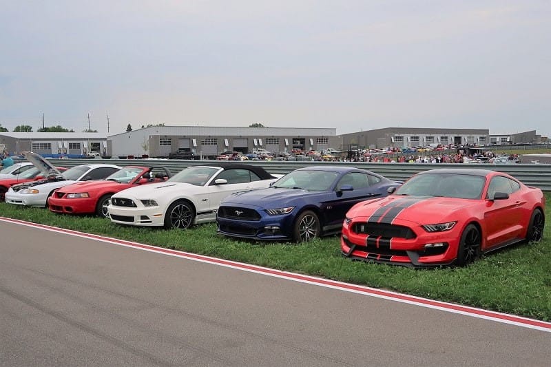 A lineup of a variety of Ford Mustangs on display at the M1 Concourse 
