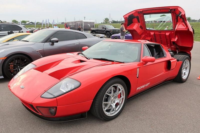 A red Ford GT on display with the trunk up 
