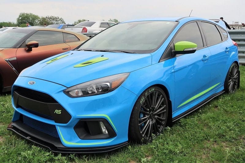 A front side view of a blue Ford Focus RS on display 
