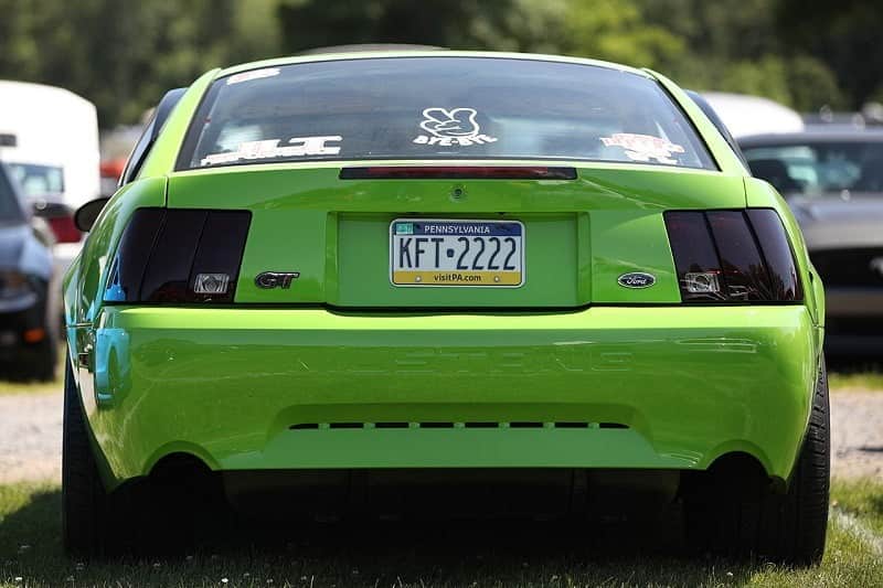 The back end of a light green Ford Mustang 
