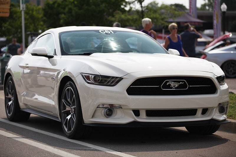 A front end view of a white Ford Mustang on display 