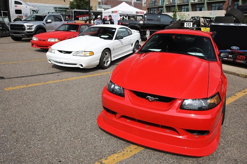 A front end view of a red Ford Mustang on display 