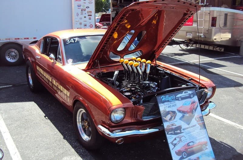A classic orange Mustang on display 