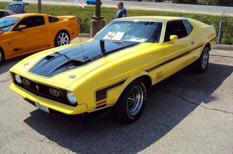 A front side view of a classic yellow and black Mustang 