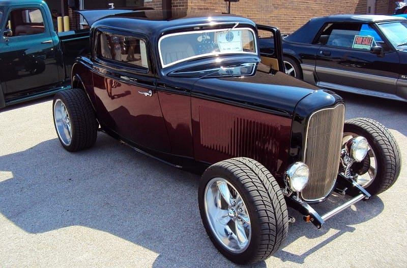 A front side view of a hot rod on display 