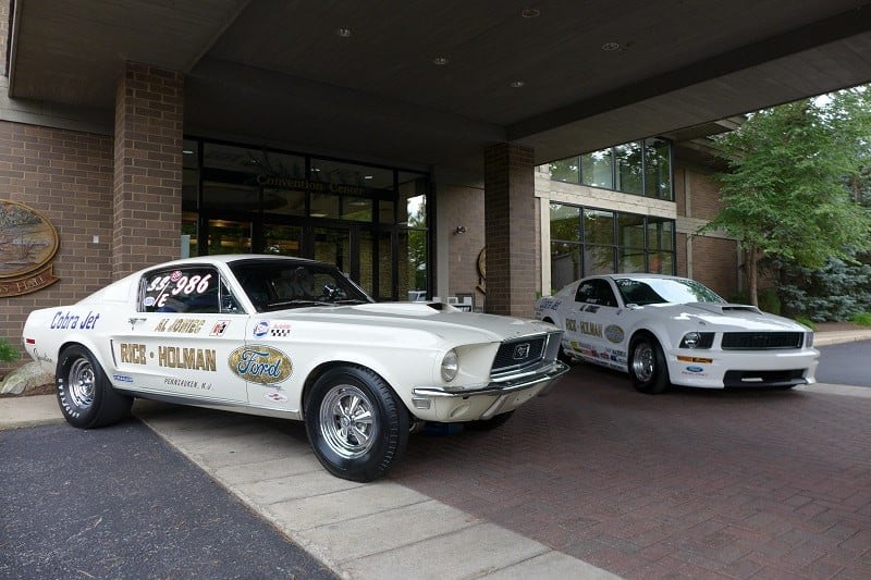 A current and classic white Mustang Cobra Jet on display 