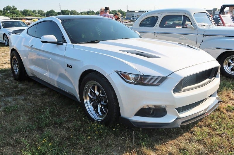 A front side view of a white Ford Mustang 