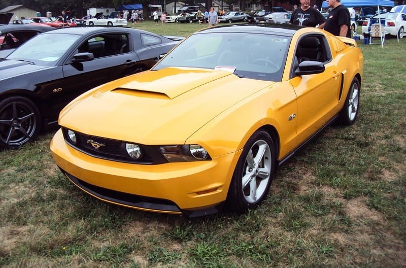 A front side view of a yellow Ford Mustang 