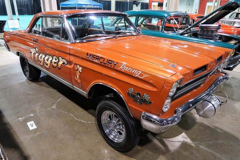 An orange Mercury Racing vehicle on display 