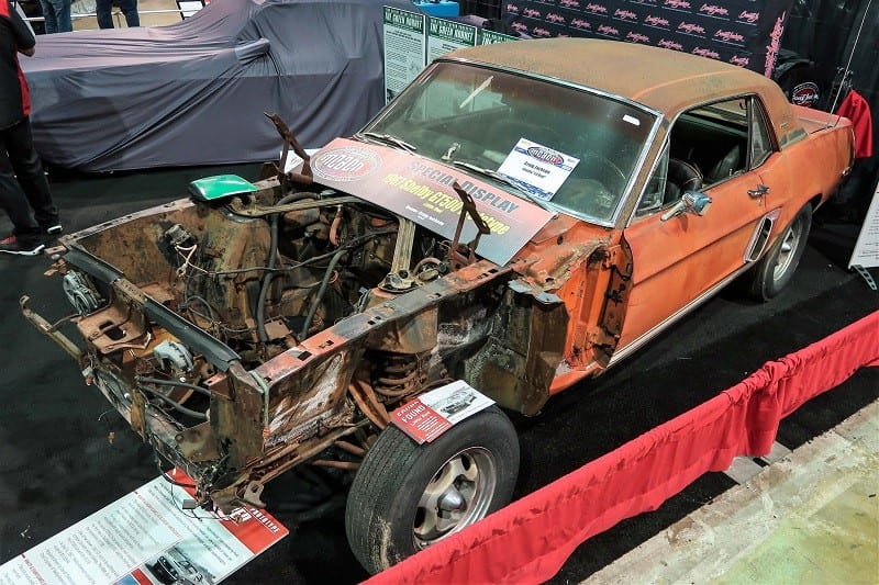 A view from above a damaged classic vehicle on display 