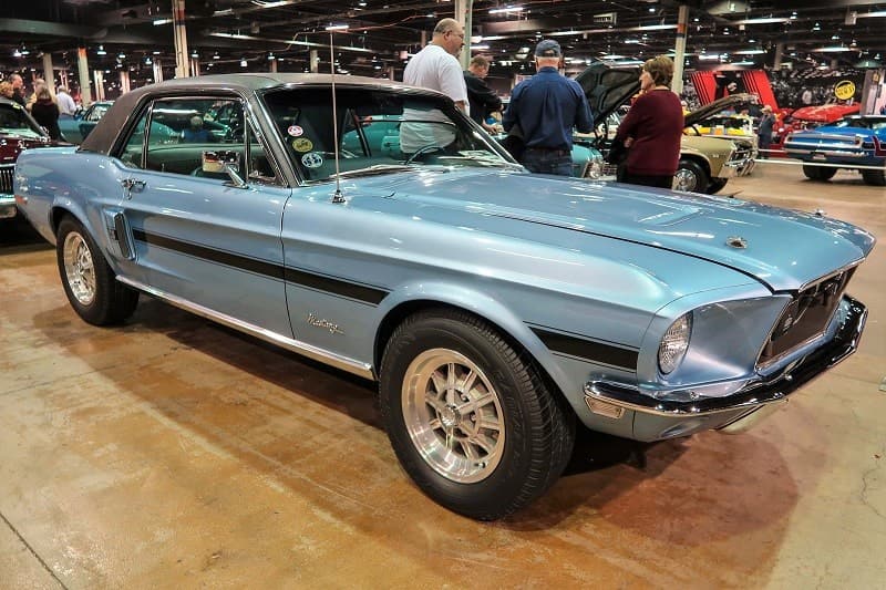 A side view of a classic light blue Mustang on display 