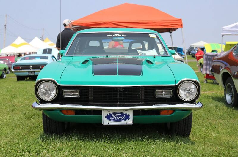 Front of a green Mustang parked on the grass