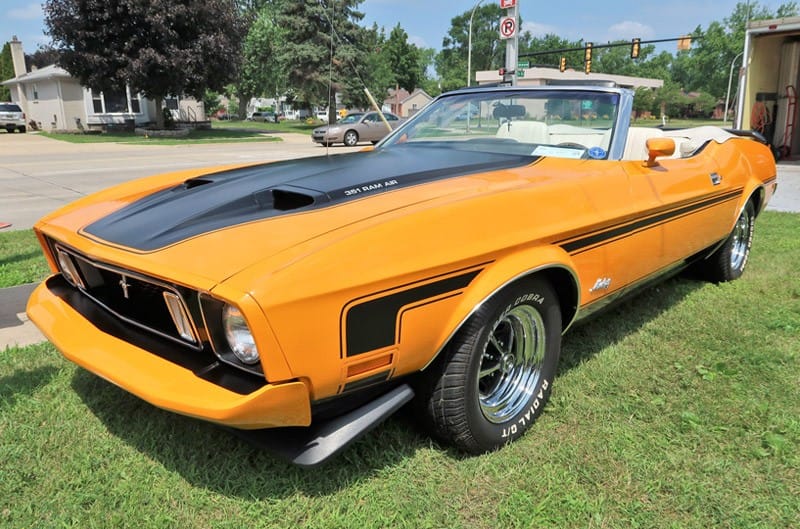 A front side view of a classic orange Mustang 