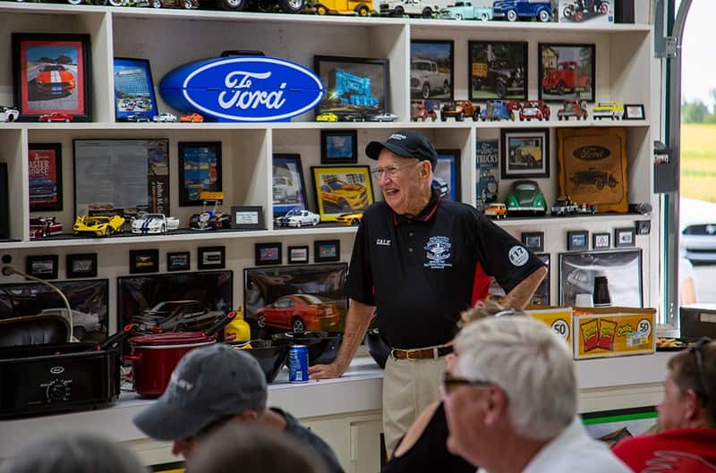 Man standing in front of shelves of diecast Fords