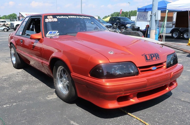 Copper colored Foxbody Mustang with UPR products logo on front