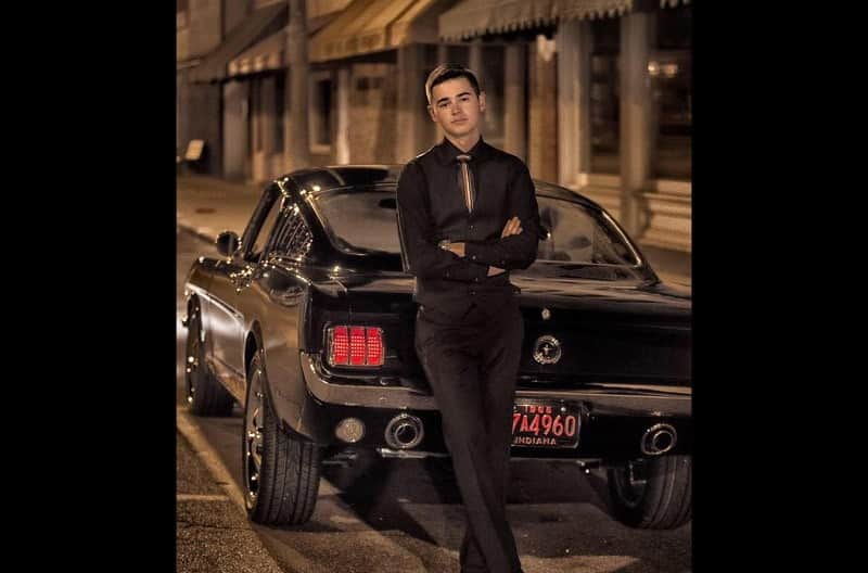 Bradley Belcher is pictured with his black 1965 Mustang GT Fastback