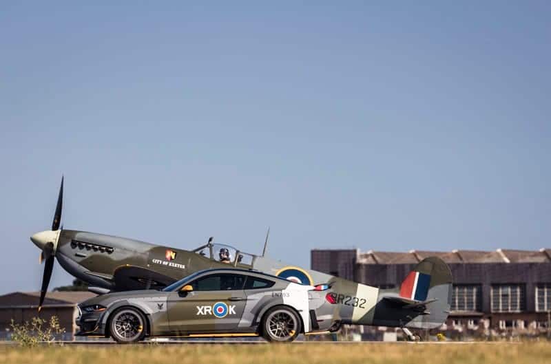 Outside, a Ford Eagle Squadron Mustang GT is pictured cruising side-by-side with an Eagle Squadron Spitfire