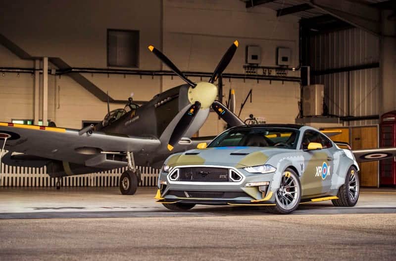 The Ford Eagle Squadron Mustang GT inside a garage with Eagle Squadron Spitfire in the back