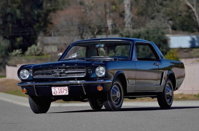 An outdoor picture of Bob Fria's 1965 Mustang hardtop in Caspian Blue, which will be available for at the Scottsdale Auction